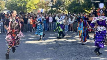 TMS Students and guests jingle dress, fancy shall dress, and chicken dance in a cirlce on Victoria Street in front of The Capitol Theater.